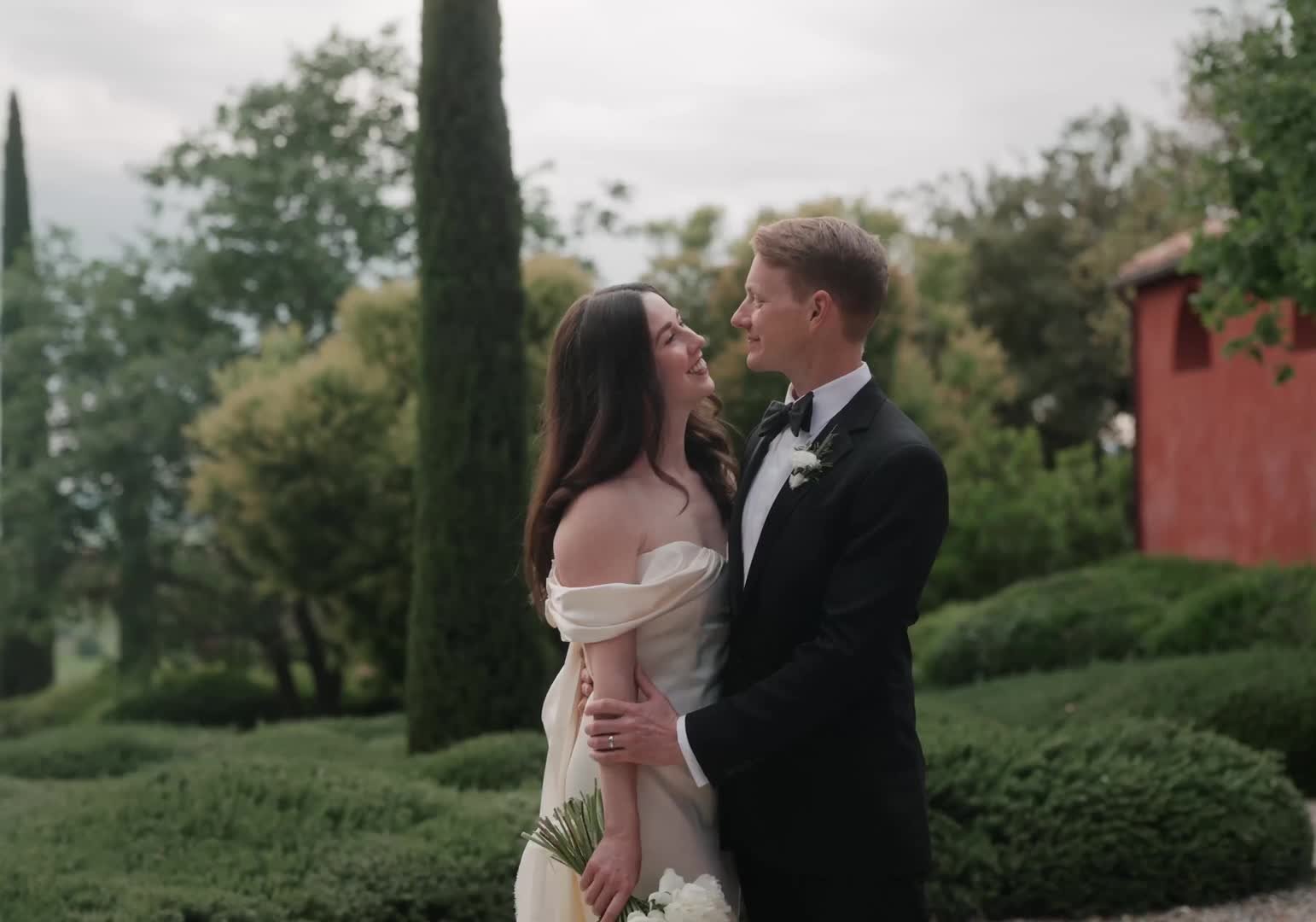 Jenna and Taylor in the gardens of their Tuscan wedding venue